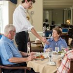 A server hands a resident a plate of food at The Village at Penn State in State College, PA.