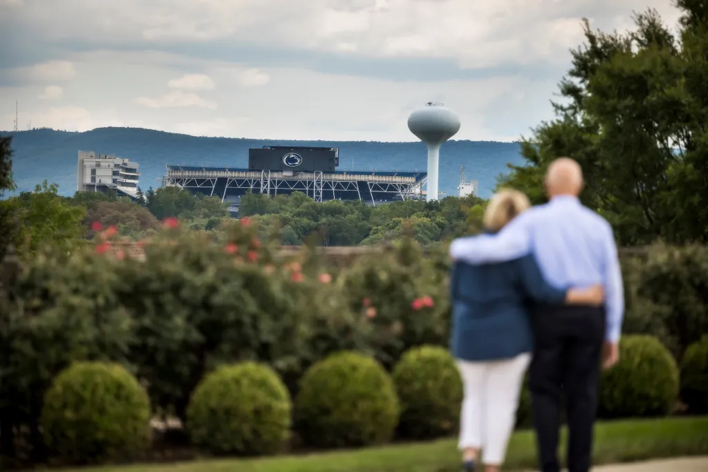 Couple at The Village at Penn State looks at Beaver Stadium in State College, PA